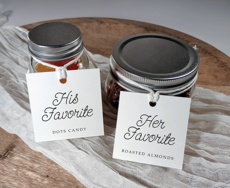 Two jars with labels 'His Favorite' and 'Her Favorite' on a wooden surface.