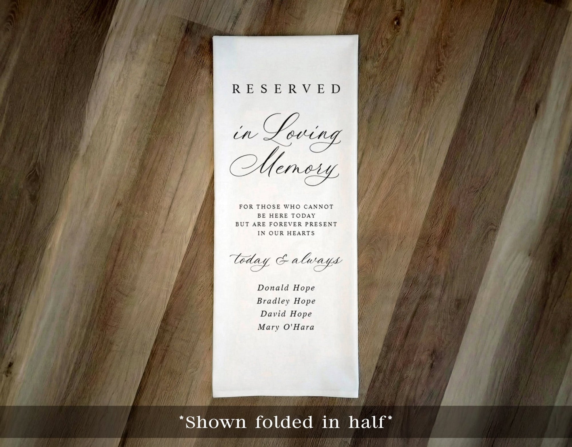 Reserved in Loving Memory fabric cloth sign on a wooden surface