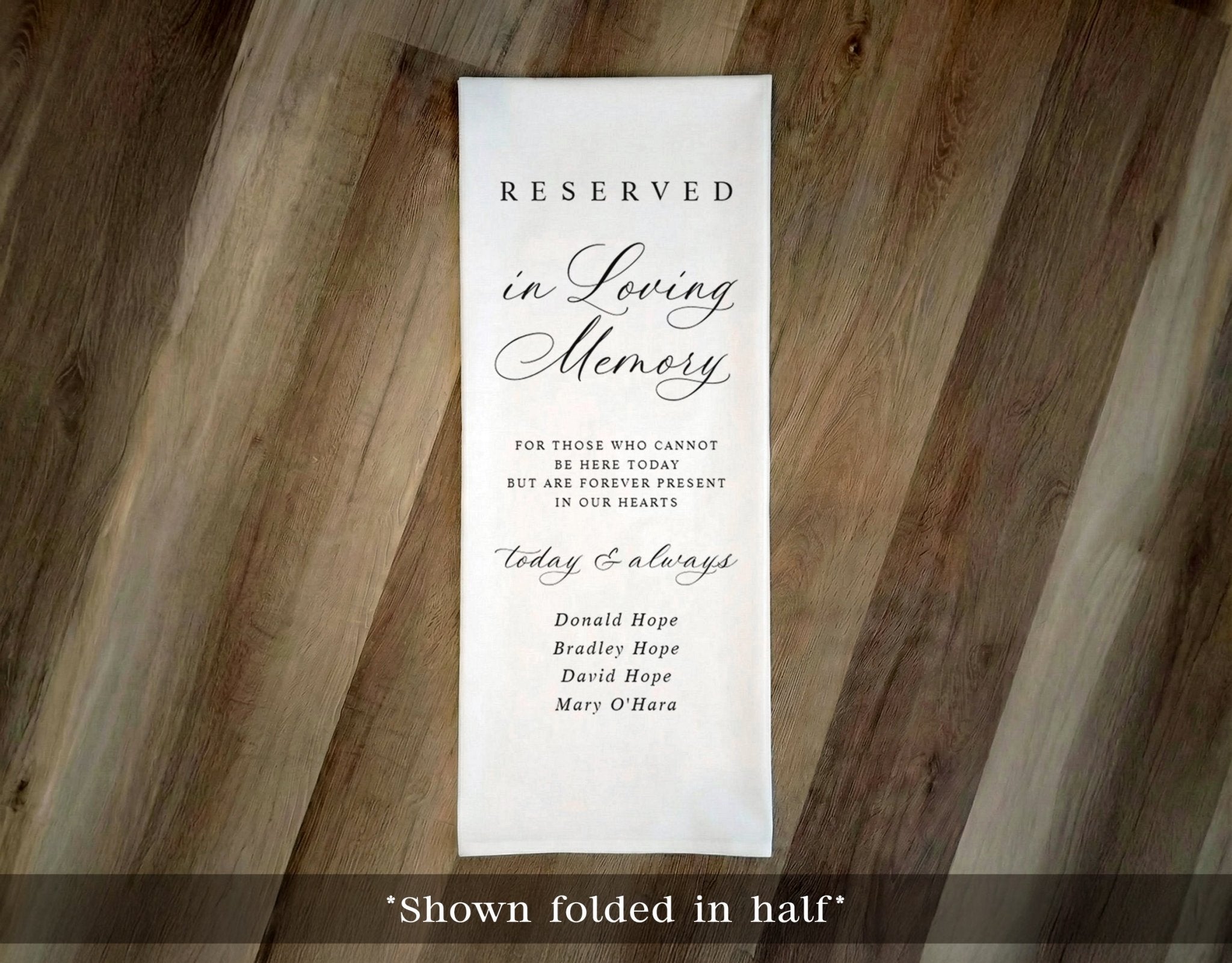 Reserved in Loving Memory fabric cloth sign on a wooden surface