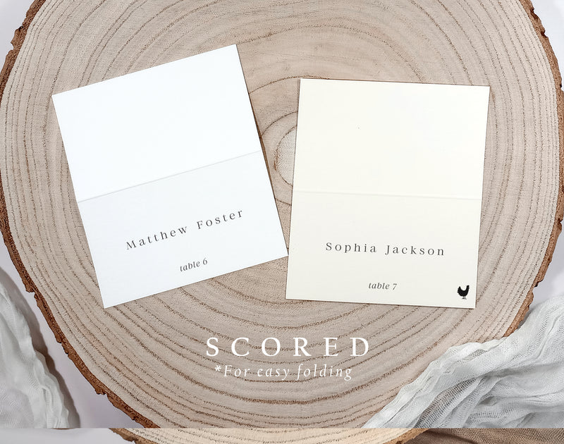 Printed name cards shown in both flat and scored folded formats, on wood background.