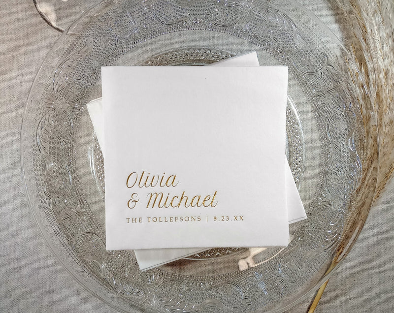 White foil stamped napkins with gold foil names on a decorative glass plate