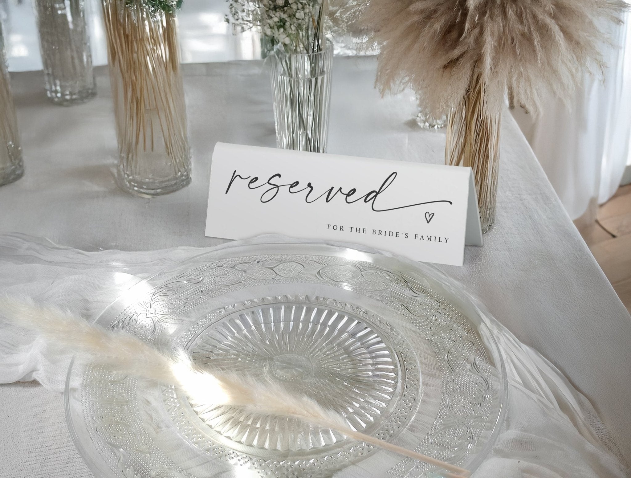 Reserved sign for the bride's family on a table with decorative elements.