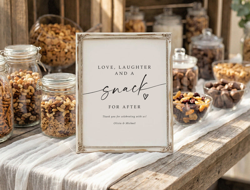 Printed wedding sign - snacks for after - sitting on a snack table filled with jars of pretzels, nuts and various snacks.