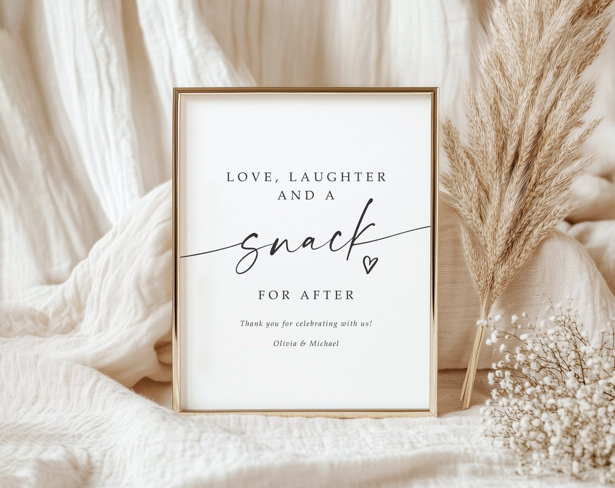 Printed wedding sign that says Love, Laughter and a Snack for After in black script on white cardstock, framed and styled with neutral wedding décor