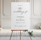 Wedding welcome sign on an easel with floral decorations in a elegant room.