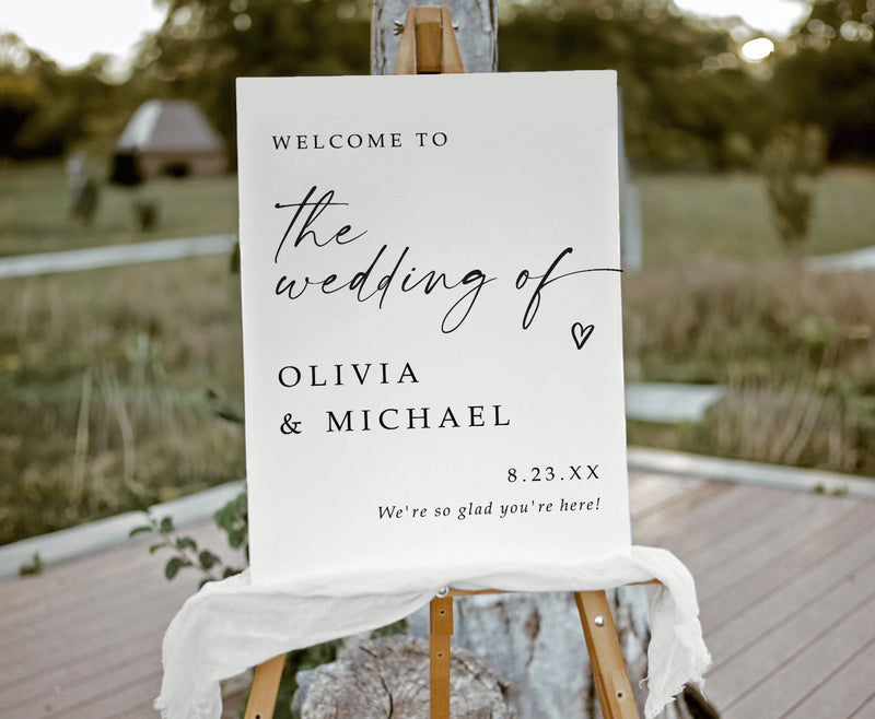 Elegant handwriting wedding welcome sign on foam board displayed on wooden easel
