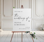 Wedding welcome sign on an easel with floral decorations in a elegant room.