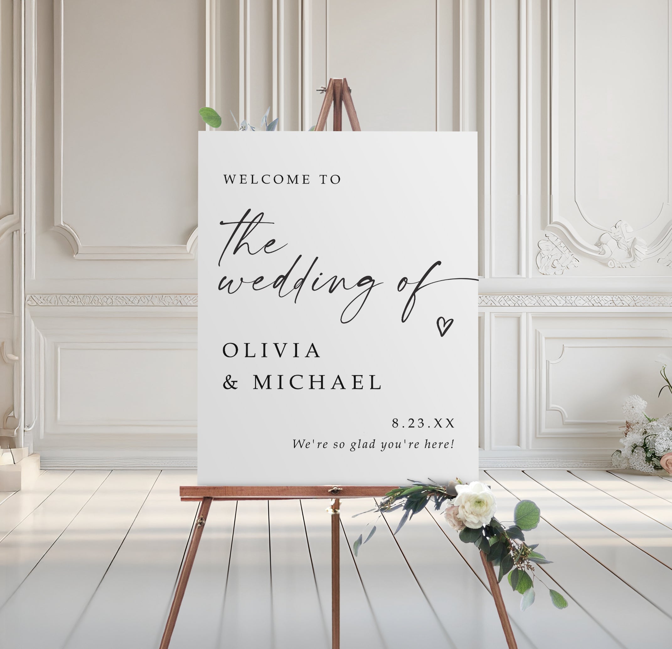 Wedding welcome sign on an easel with floral decorations in a elegant room.