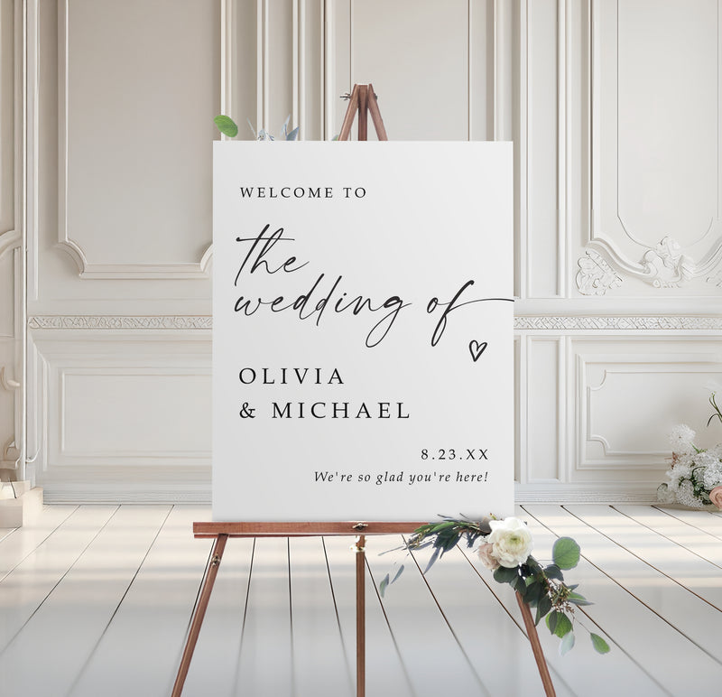 Wedding welcome sign on an easel with floral decorations in a elegant room.