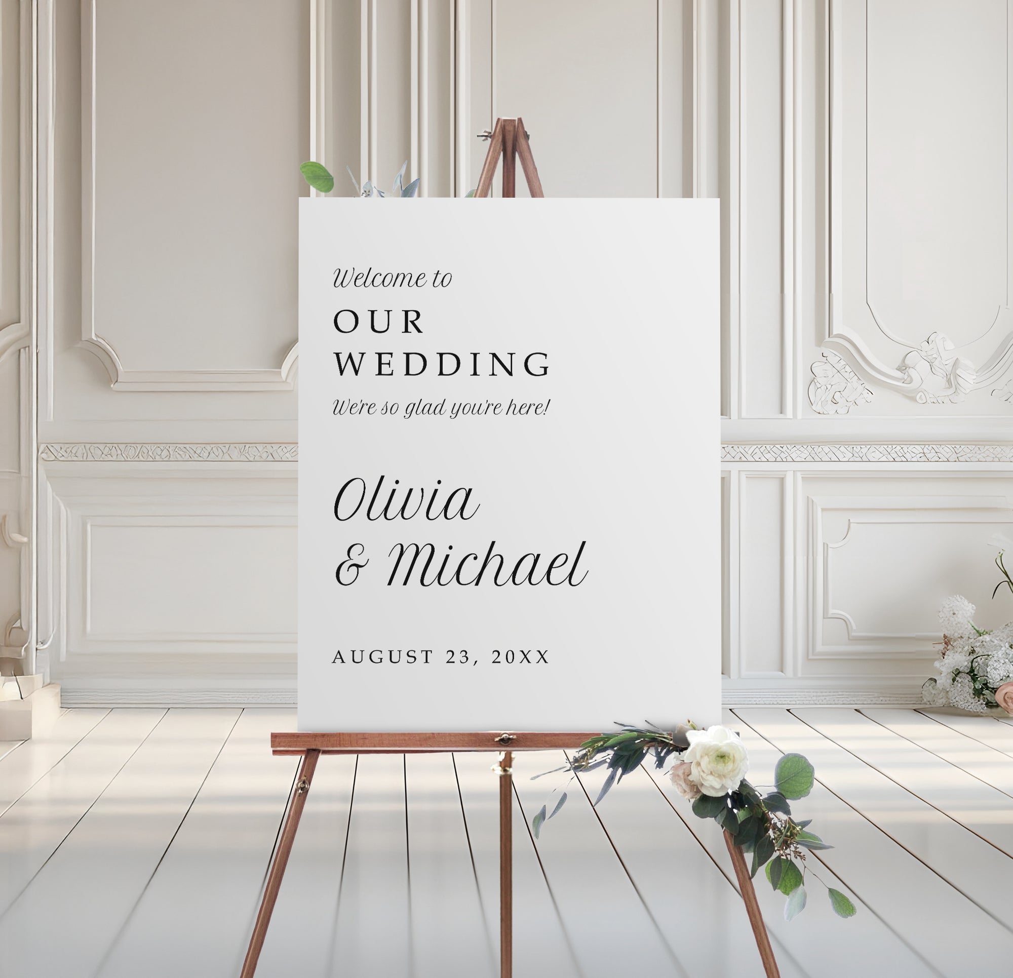 minimalist wedding welcome sign in serif font on foam board with floral base