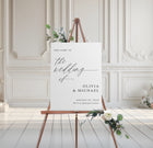 Wedding welcome sign on an easel with floral decorations in a elegant room.