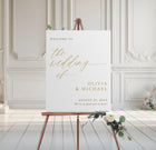 Wedding welcome sign on an easel with floral decorations in a elegant room.