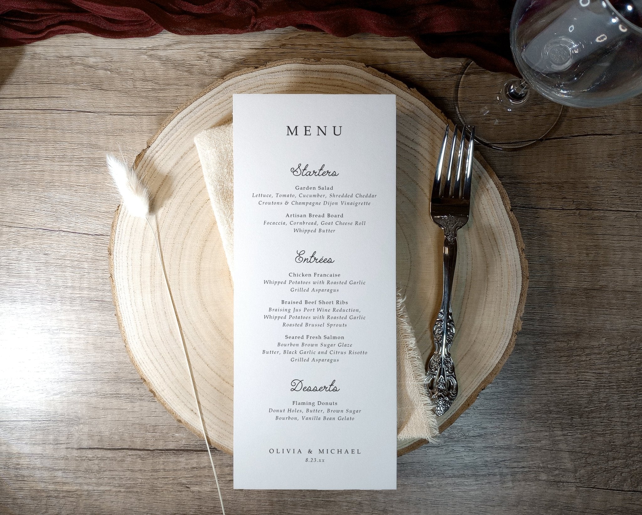 Wedding menu with clean layout and handwriting font placed on a charger plate.