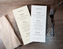 Two whimsical handwritten menus laid out on a neutral table setting.