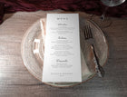 Menu with modern serif and handwriting details styled with flatware and napkin.